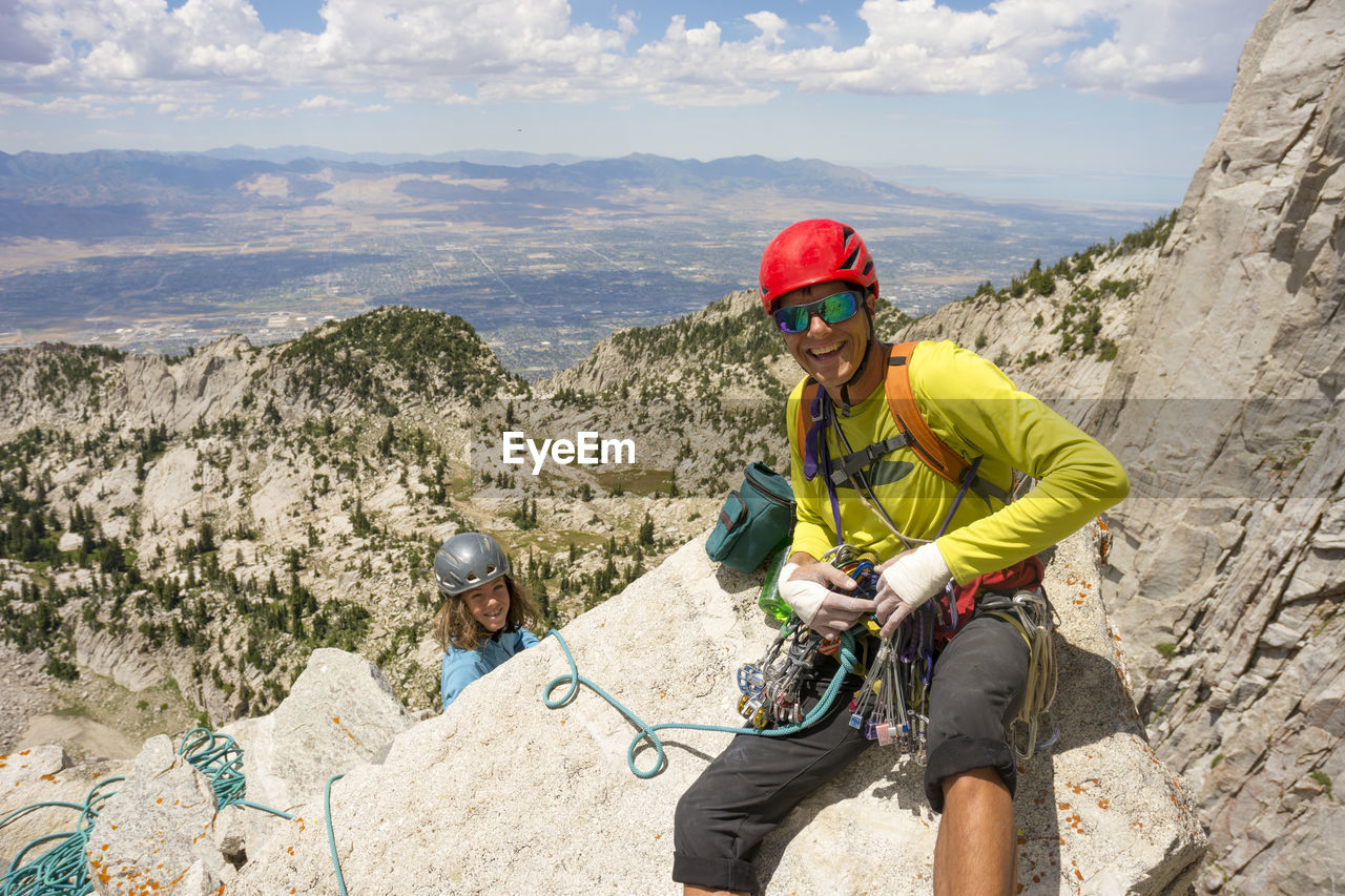 A father and son rock climbing near lone peak, utah