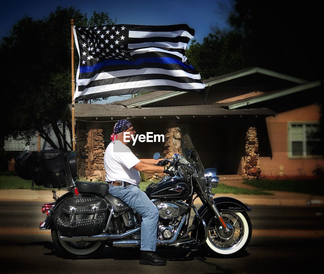 MAN RIDING MOTORCYCLE ON BICYCLE