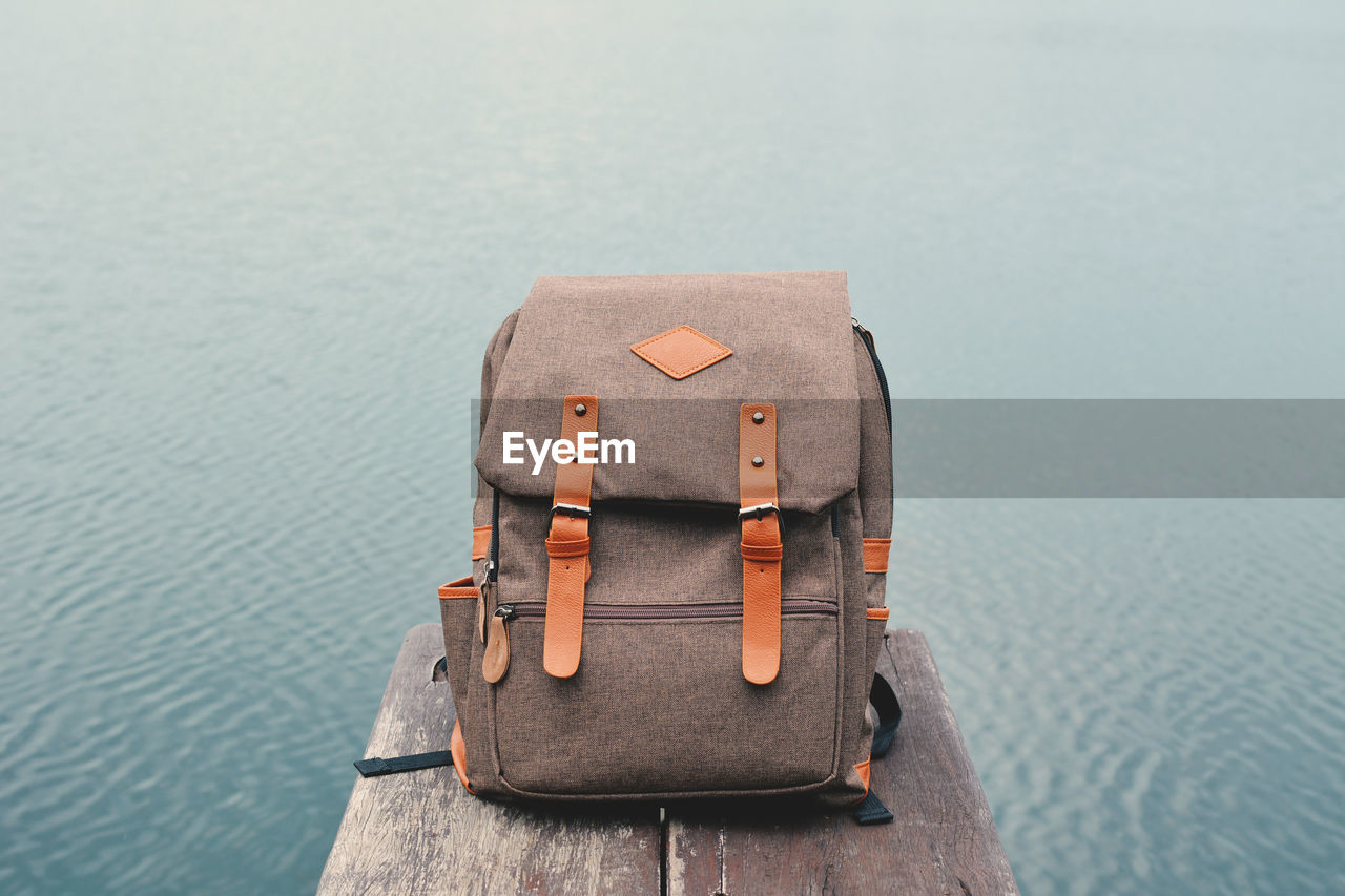 Close-up of backpack against sea