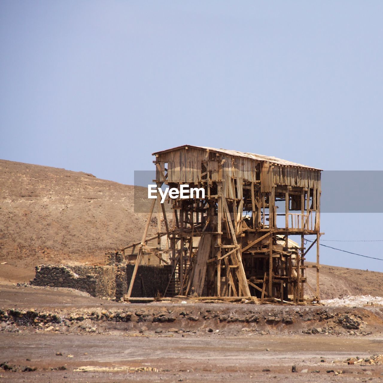 Abandoned built structure on desert against clear sky