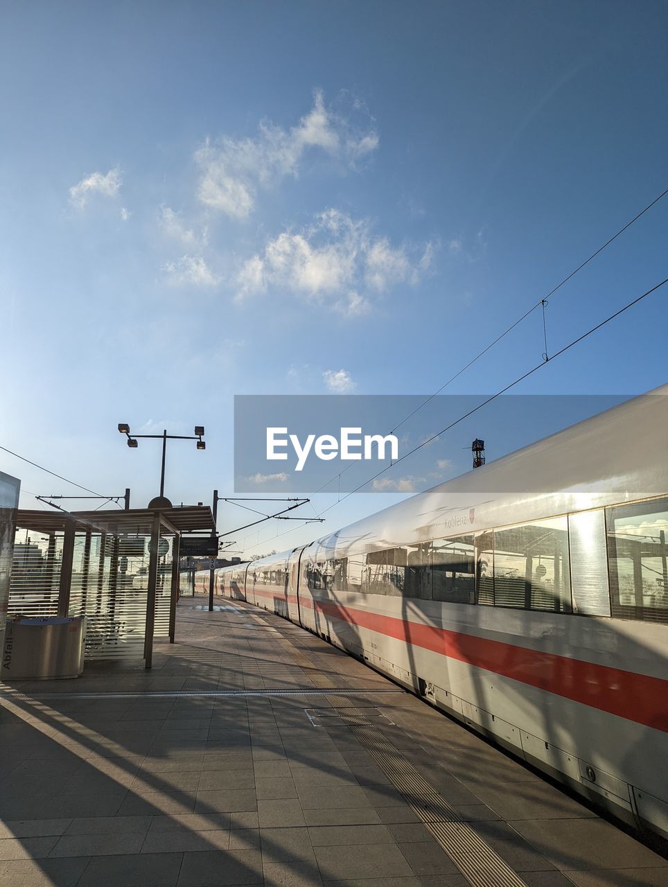 transportation, sky, rail transportation, mode of transportation, public transportation, transport, architecture, train, railroad track, railroad station, track, travel, railroad station platform, cloud, vehicle, nature, city, no people, built structure, railway, outdoors, train station, day, sunlight, motion, station, public transport, metropolitan area, blue