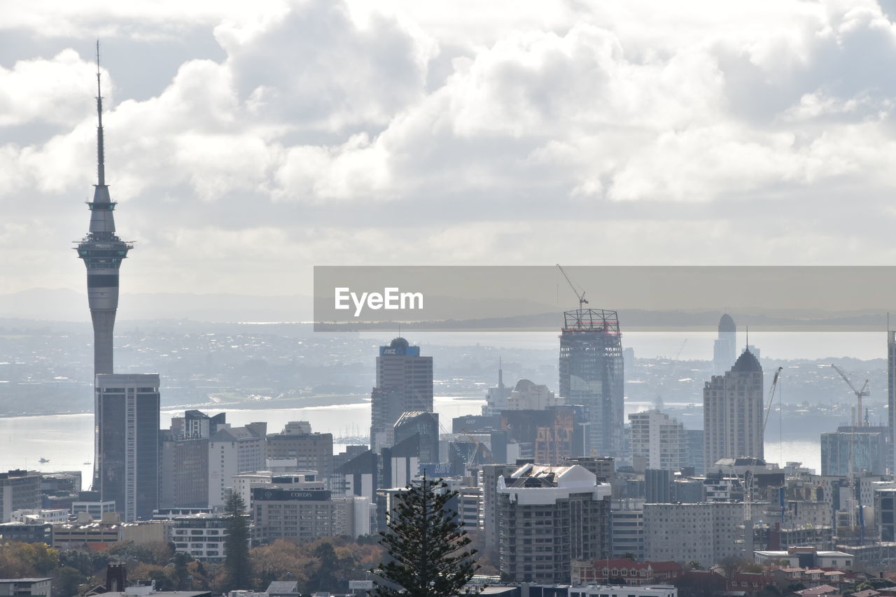 CITY BUILDINGS AGAINST CLOUDY SKY