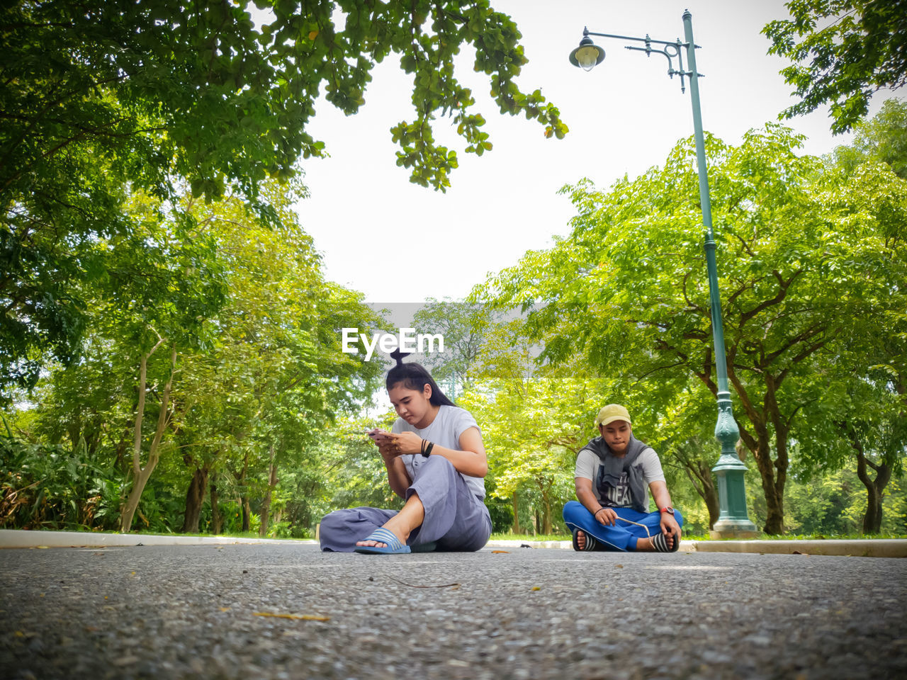 YOUNG MAN SITTING IN PARK