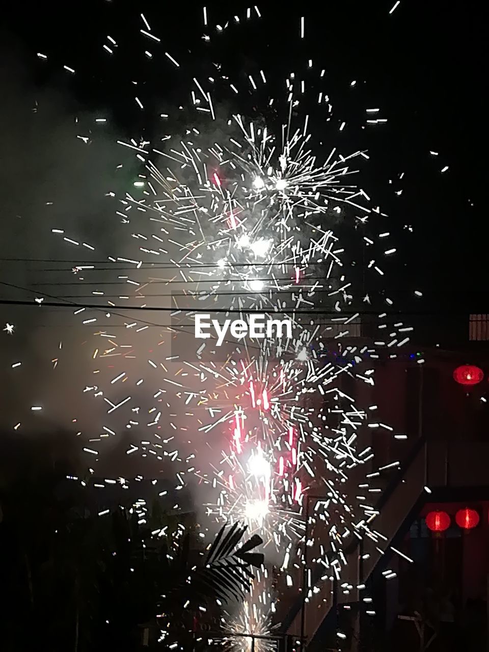 LOW ANGLE VIEW OF FIREWORKS DISPLAY AT NIGHT
