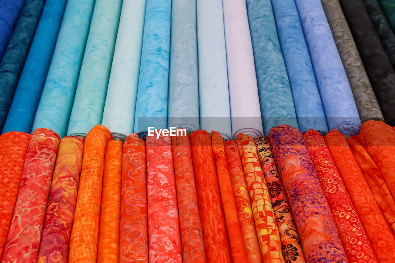 Detailed close up view on samples of cloth and fabrics in different colors found at a fabrics market