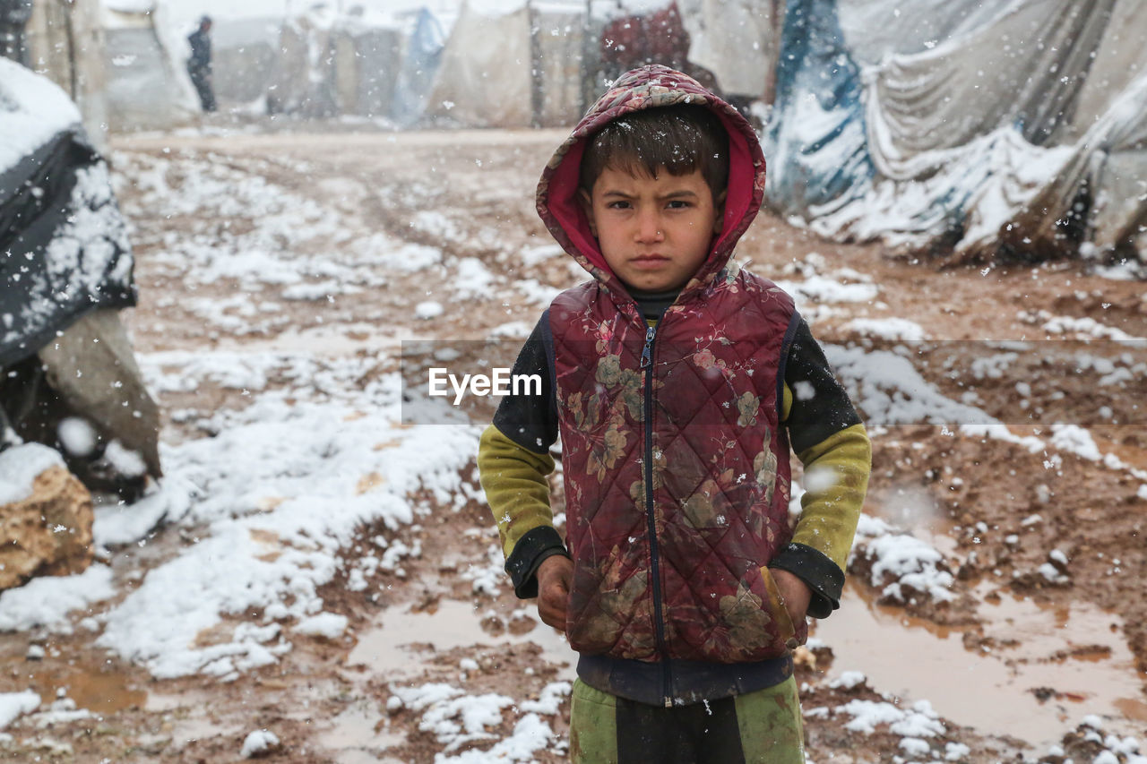 A refugee child during a snowfall on a syrian refugee camp near the turkish border.