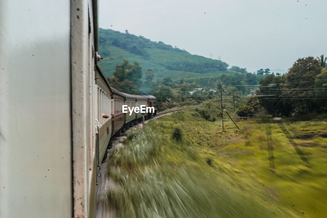 SCENIC VIEW OF TRAIN AGAINST SKY SEEN THROUGH WINDOW