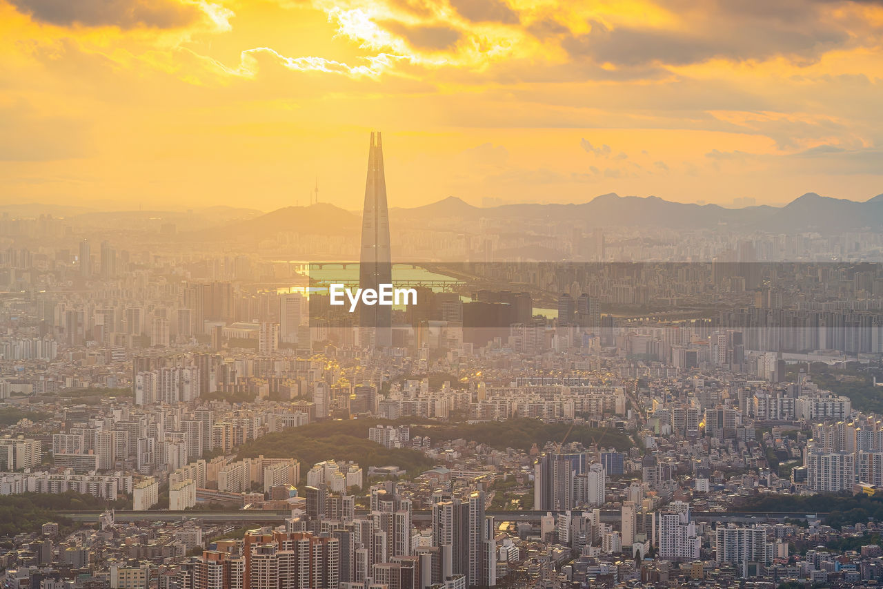 high angle view of buildings in city against sky during sunset