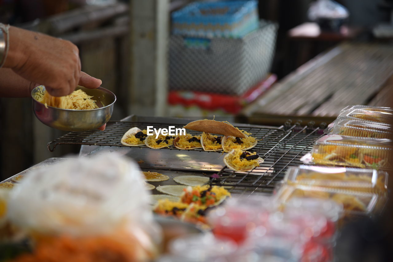 Cropped hand adjusting food on cooling rack