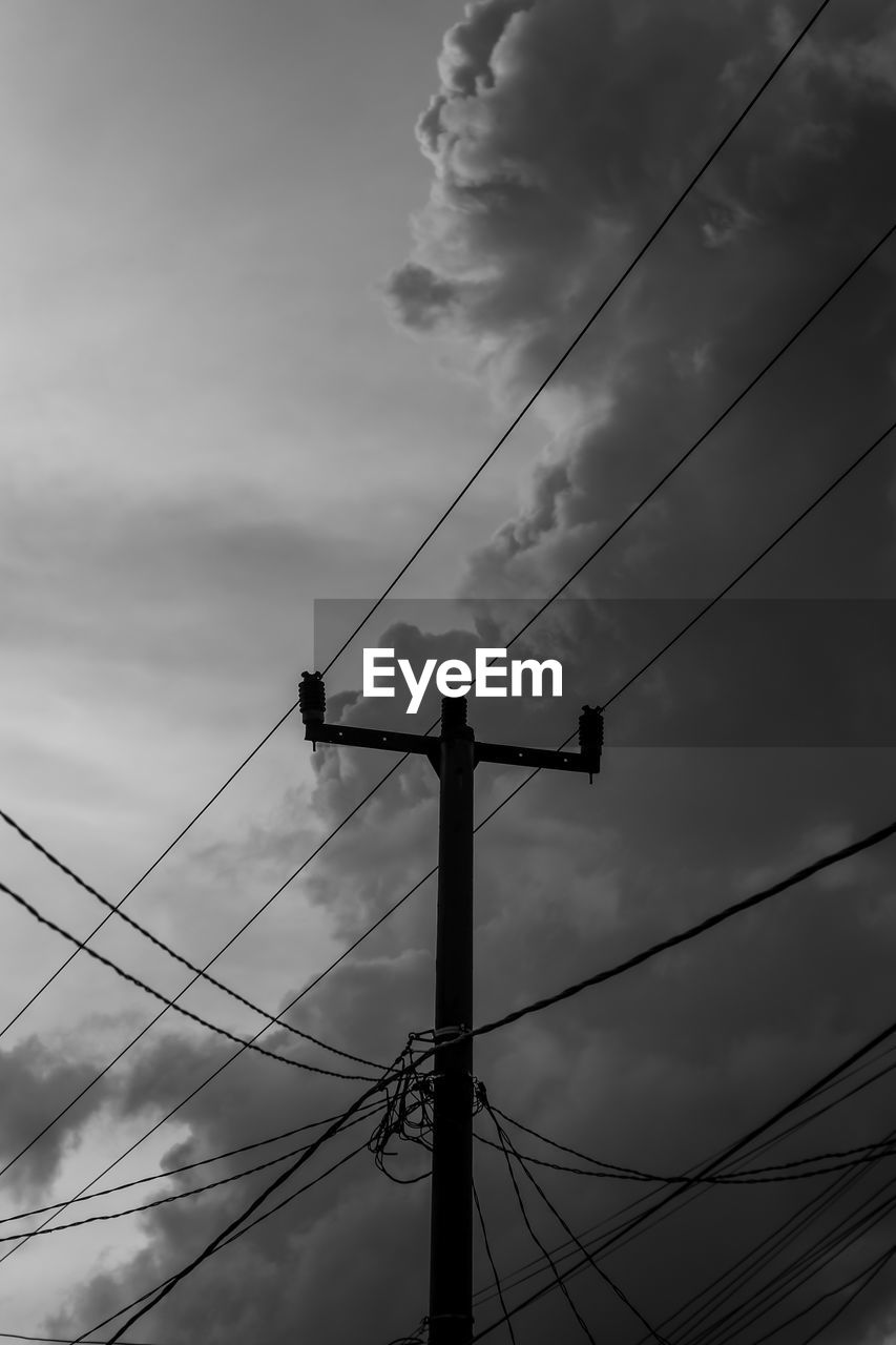 Low angle view of electricity pylon against sky