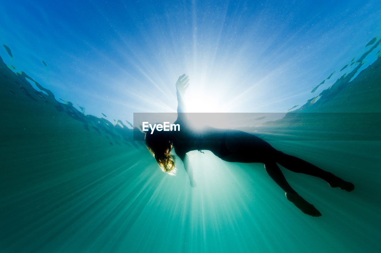 Low angle view of woman swimming in sea