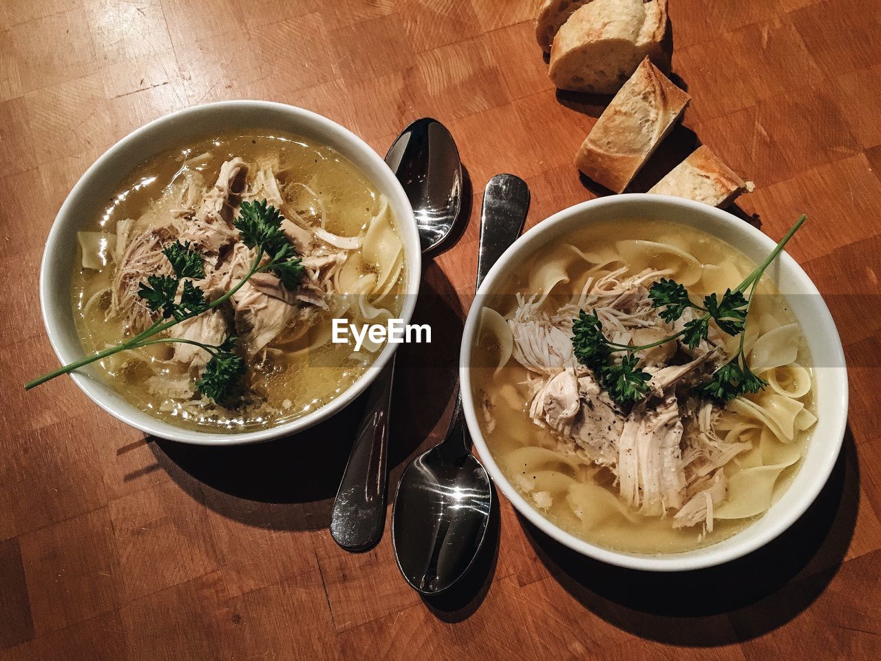 High angle view of chicken noodle soup in bowls on table