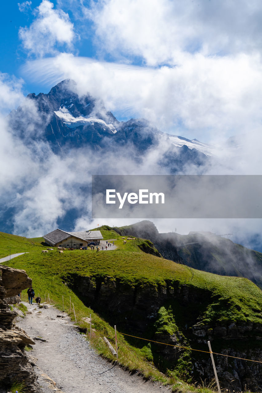 Scenic view of mountains against cloudy sky