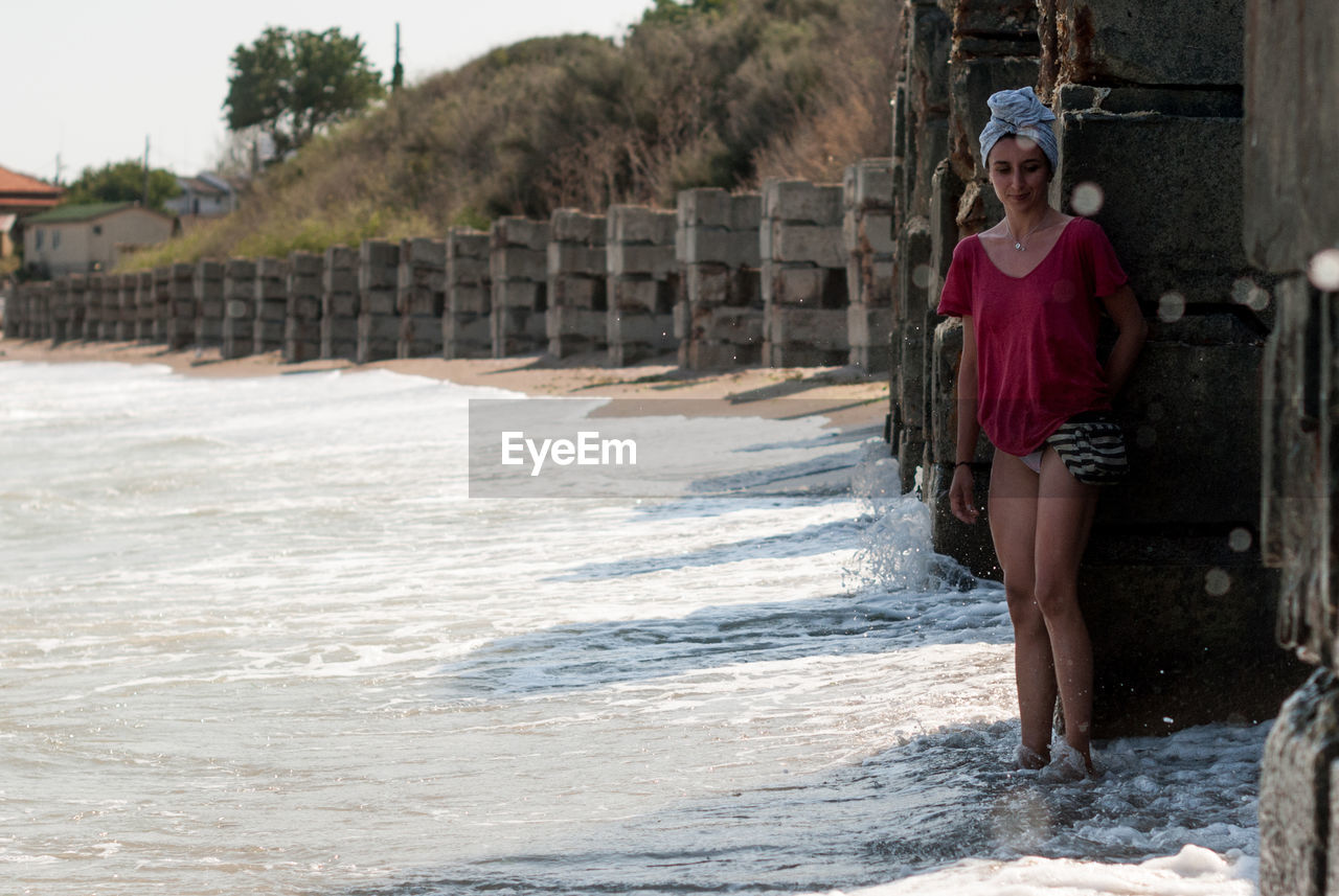 Smiling woman standing at beach