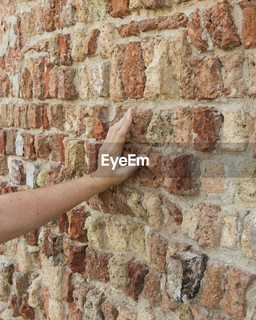 HAND TOUCHING WALL