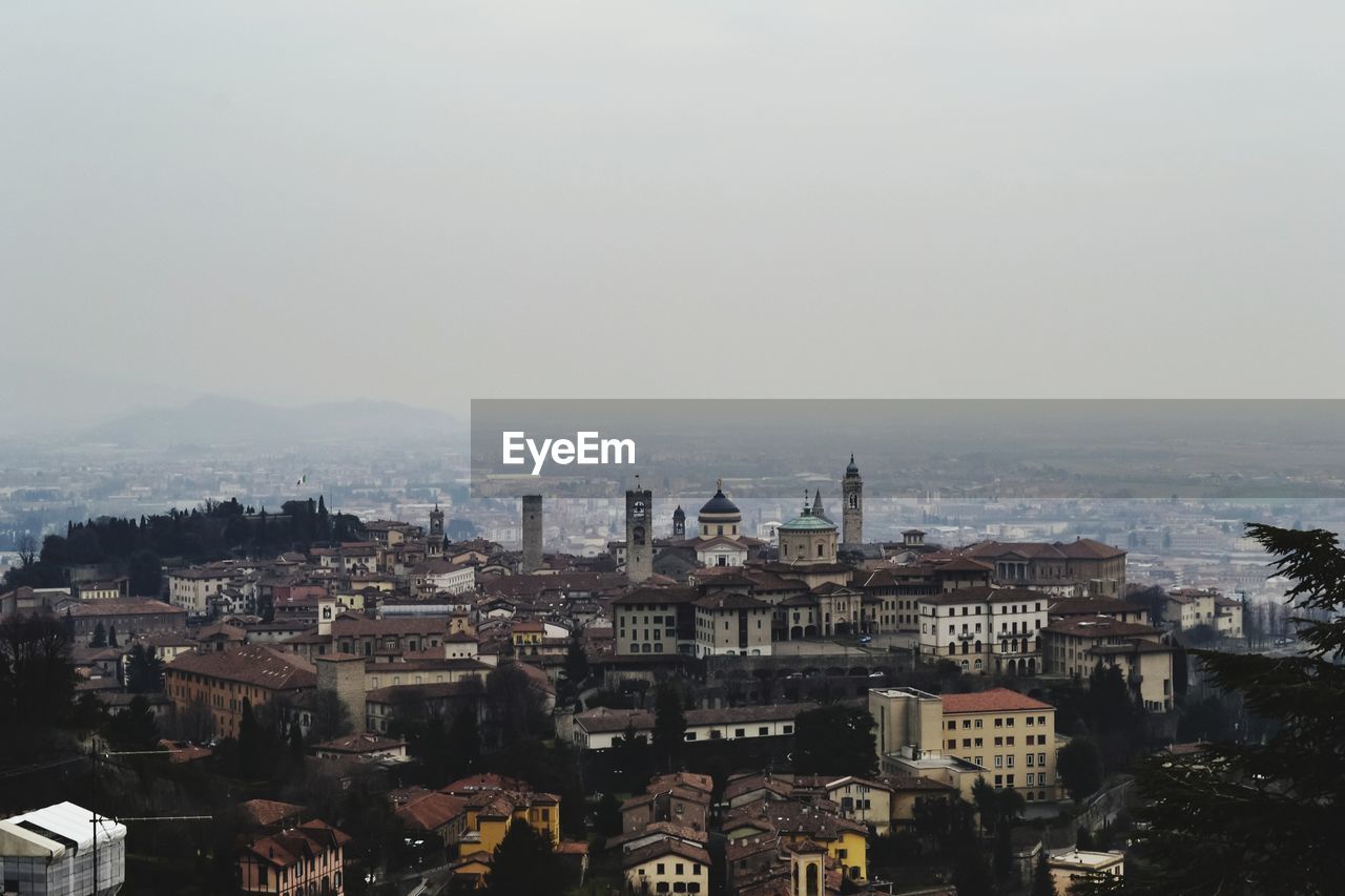 HIGH ANGLE VIEW OF CITY BUILDINGS AGAINST SKY