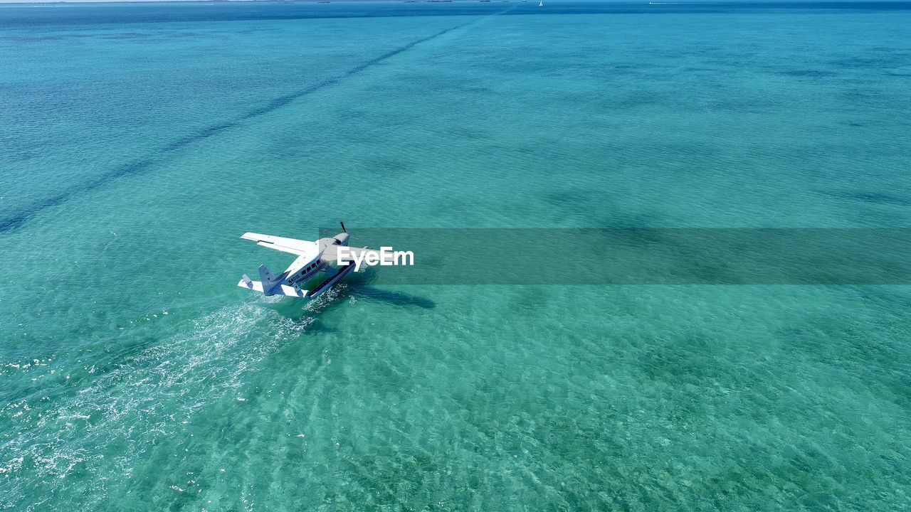 HIGH ANGLE VIEW OF AIRPLANE IN SEA