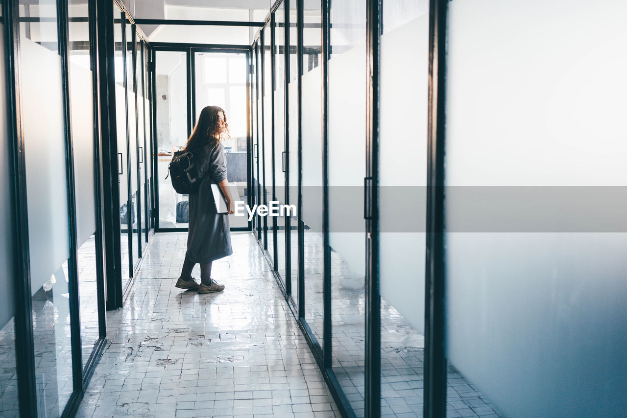 Business woman leaving office.businesswoman walking in office corridor.