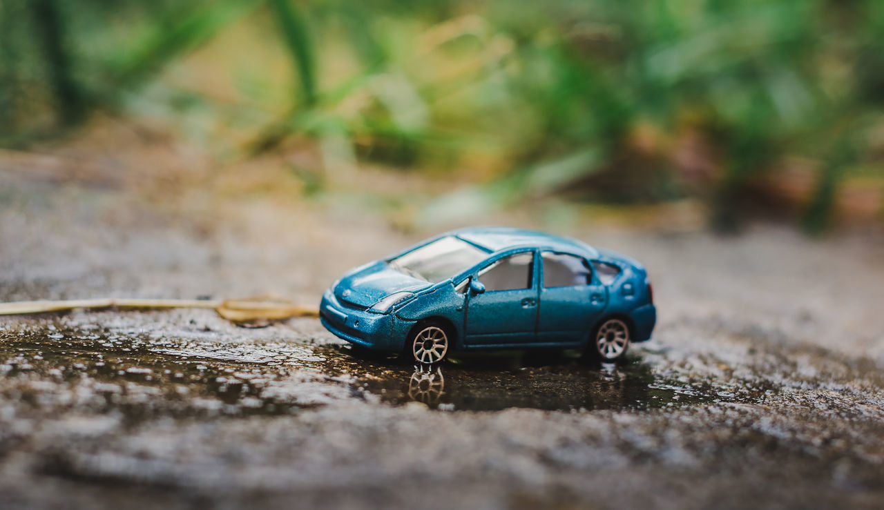 CLOSE-UP OF TOY CAR ON LAND