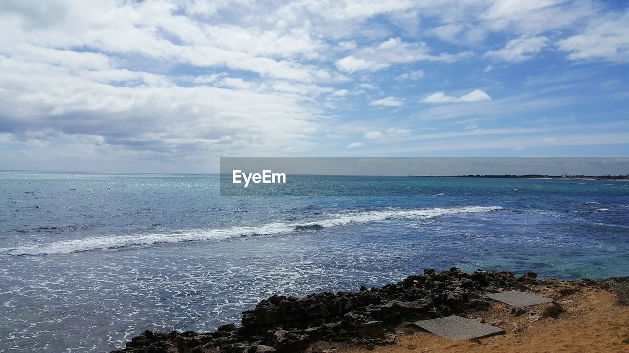 View of calm sea against cloudy sky