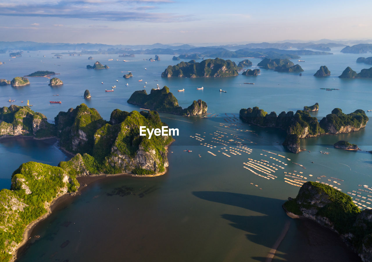 Scenic view of rock formations on bay against sky during sunset