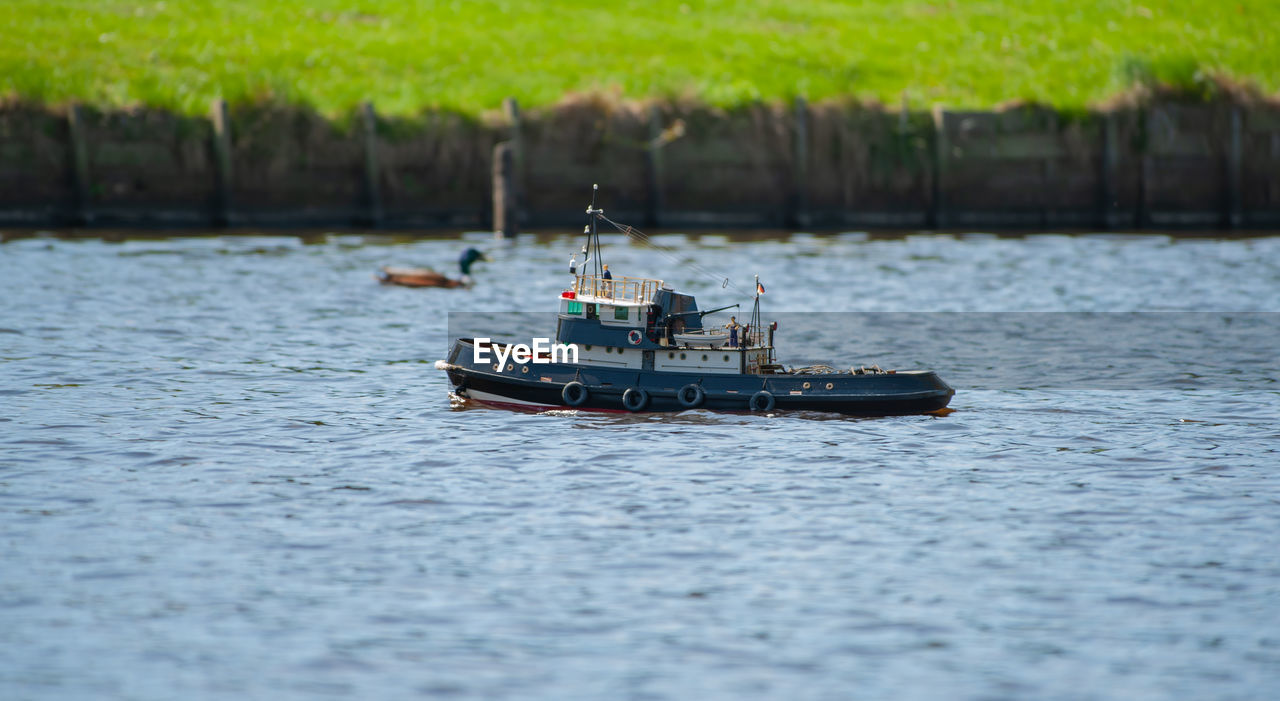 Remote controlled ship model is remote controlled on a lake