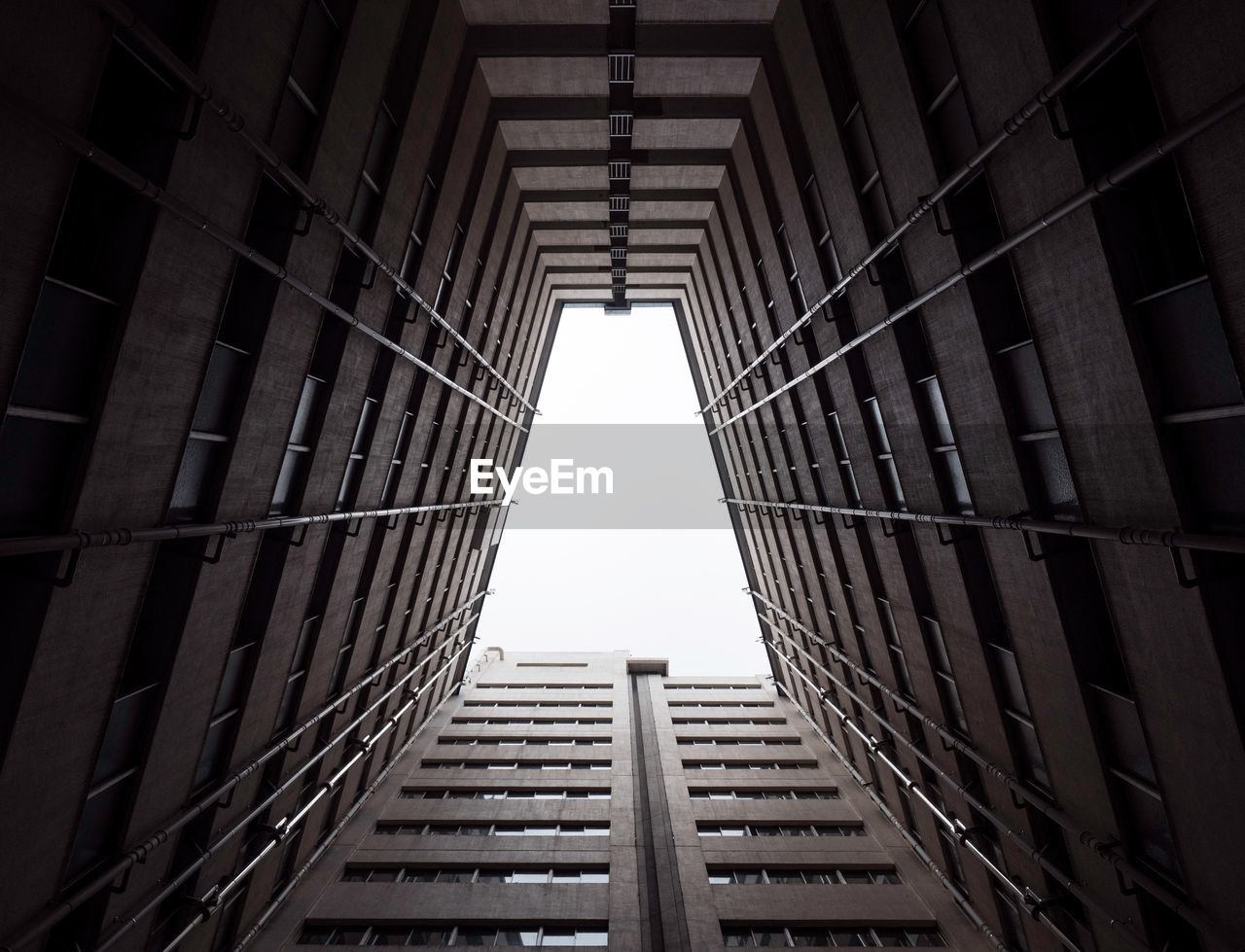 Directly below shot of buildings against clear sky