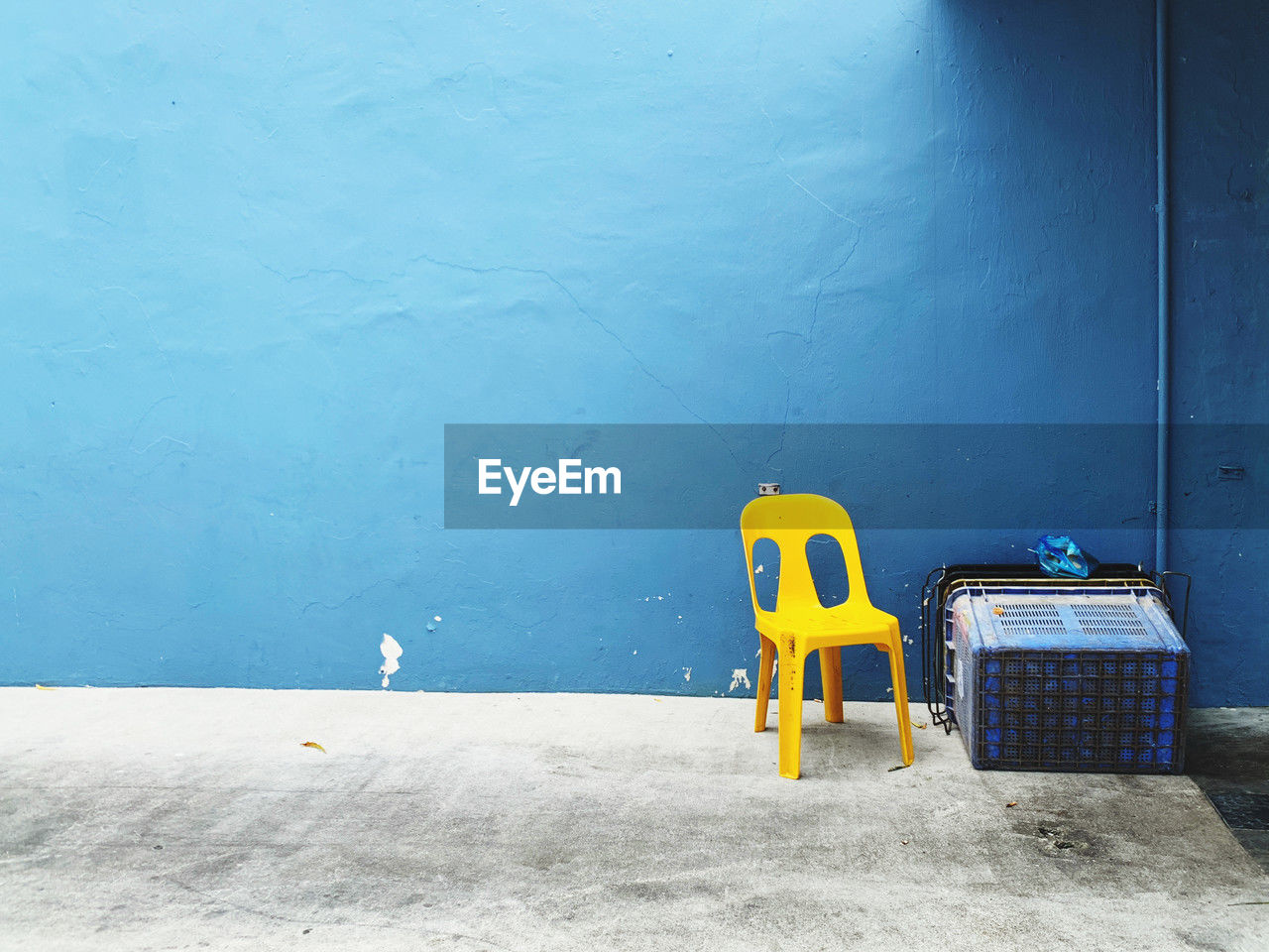 blue, yellow, wall - building feature, no people, furniture, architecture, wall, day, chair, seat, copy space, built structure, absence, floor, outdoors, nature