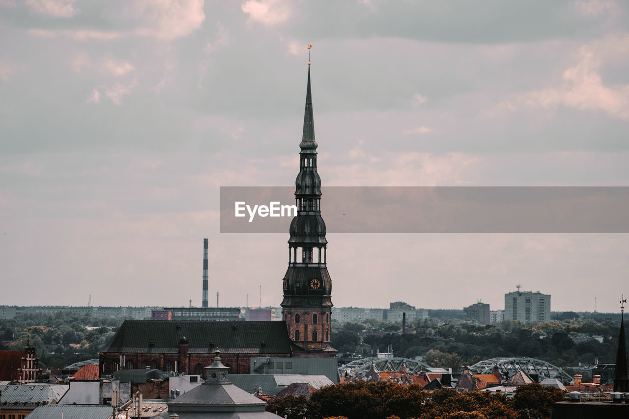  st peters church tower in riga, city against cloudy sky