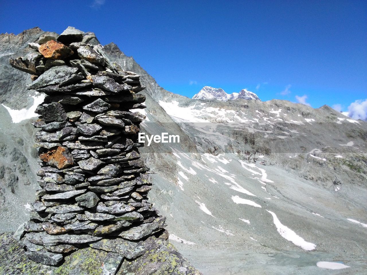 SNOWCAPPED MOUNTAINS AGAINST BLUE SKY