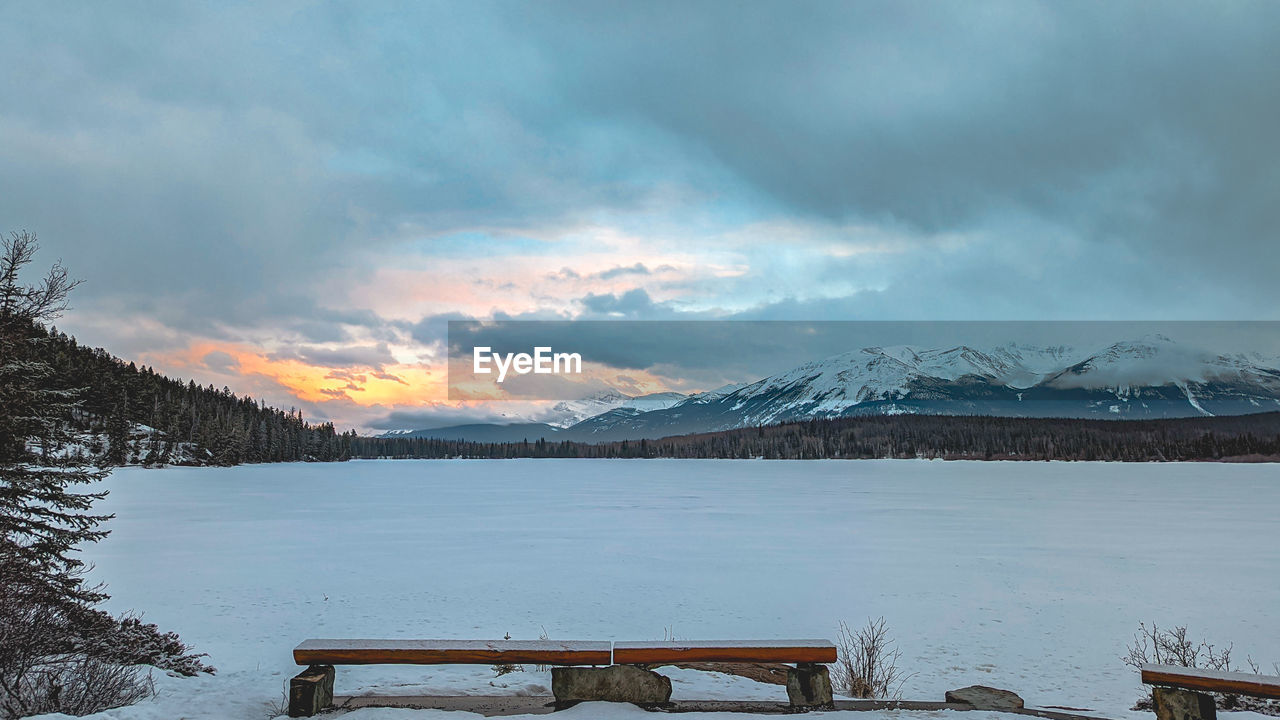 snow, cold temperature, winter, mountain, scenics - nature, sky, beauty in nature, environment, landscape, cloud, nature, water, tranquility, snowcapped mountain, tranquil scene, lake, morning, mountain range, travel destinations, land, bench, travel, tree, no people, idyllic, tourism, ice, frozen, non-urban scene, seat, wood, vacation, outdoors, forest, dramatic sky, holiday, trip, reflection, architecture, rural scene, mountain peak, overcast, fog, plant, coniferous tree, furniture, dusk, storm, sun, pinaceae, cloudscape, twilight, polar climate, relaxation