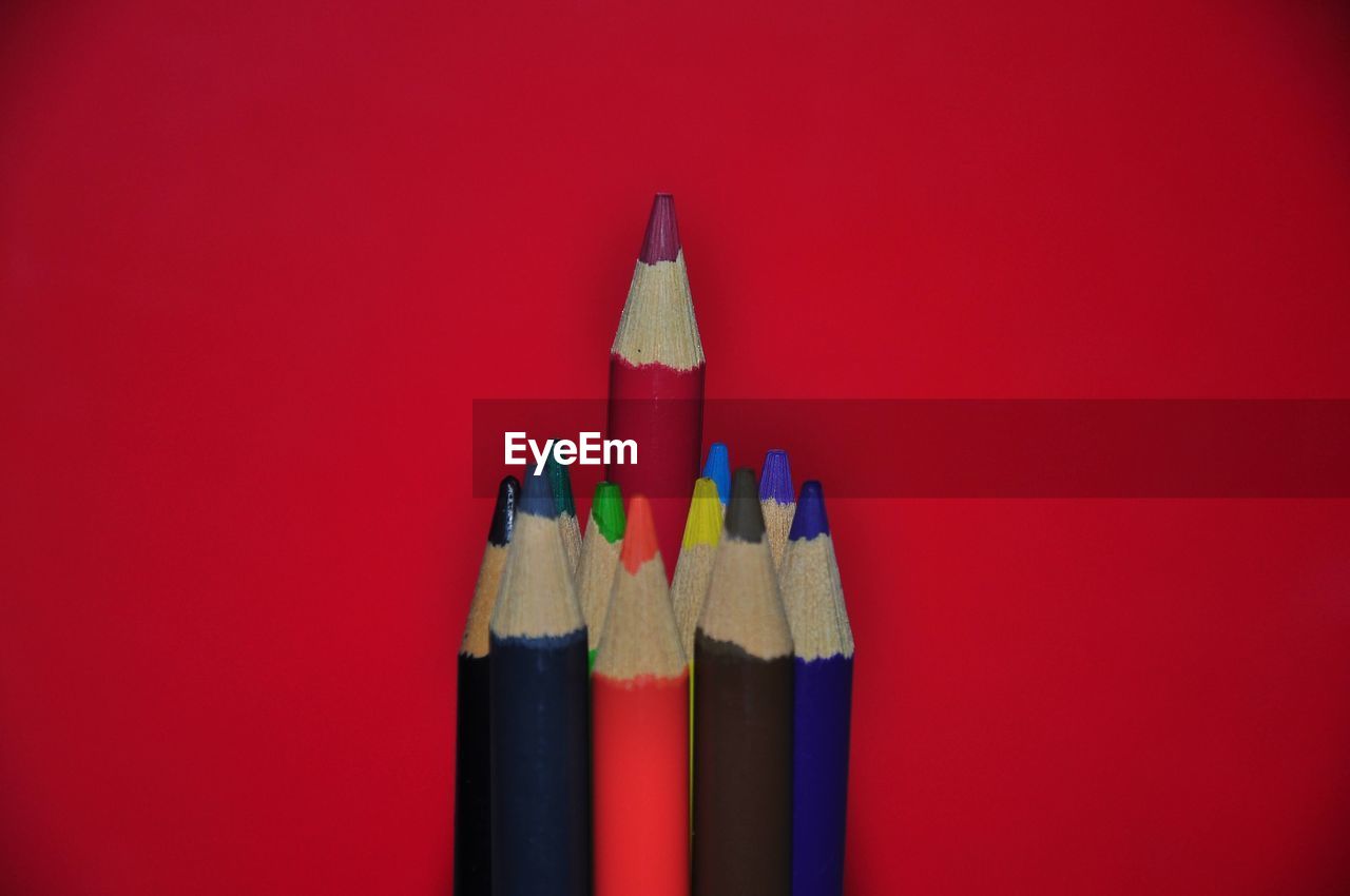 high angle view of colored pencils against yellow background