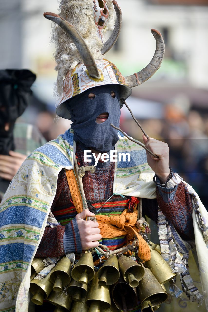 Close-up of man wearing bells