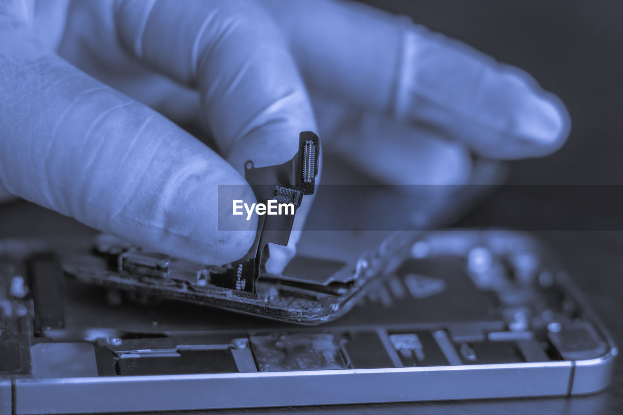 Cropped hand of person working on computer equipment