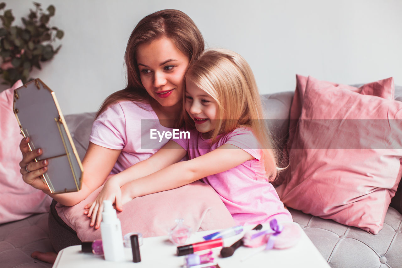 Portrait of happy girl and woman at home