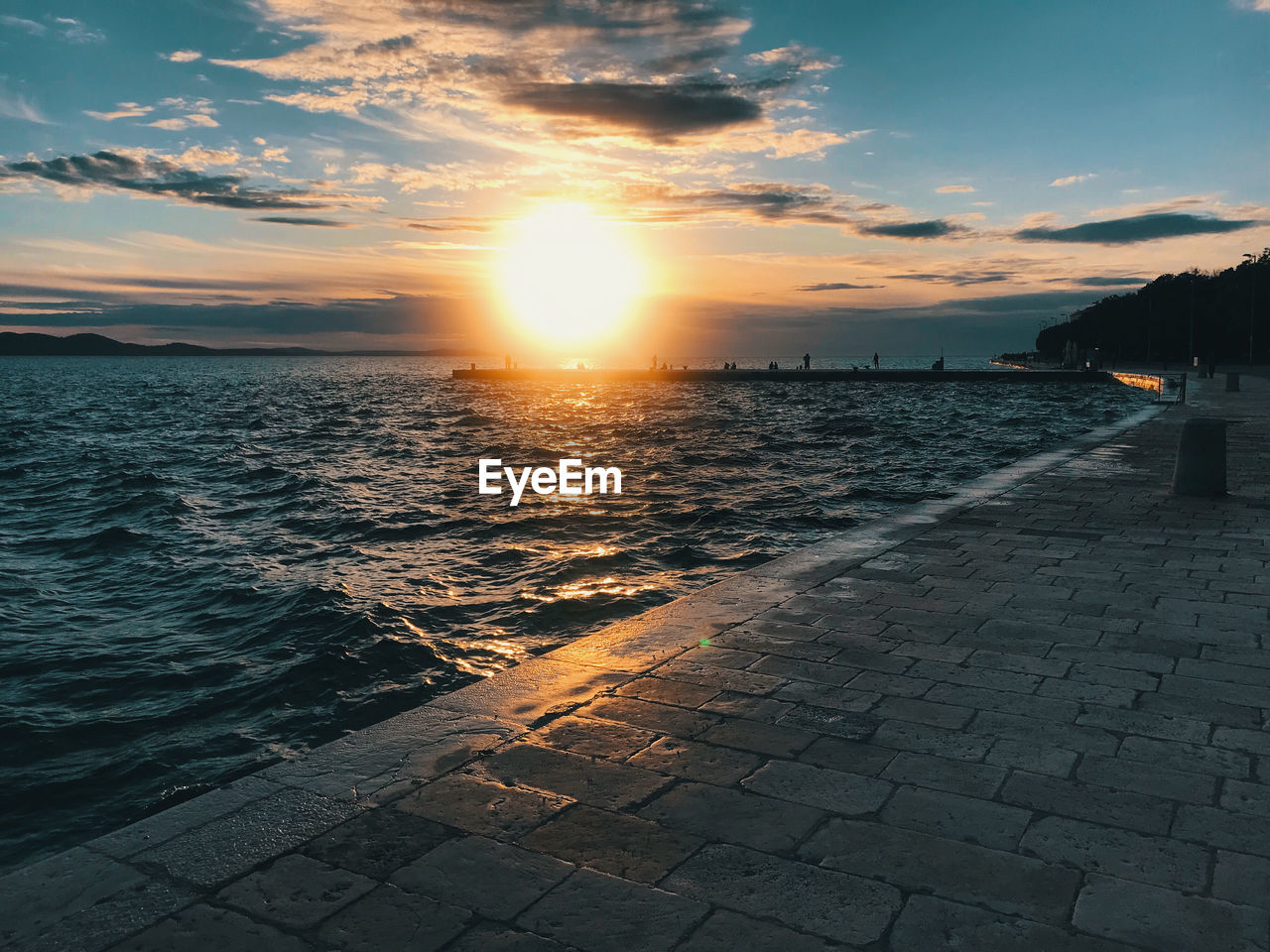 SCENIC VIEW OF SUNSET OVER SEA