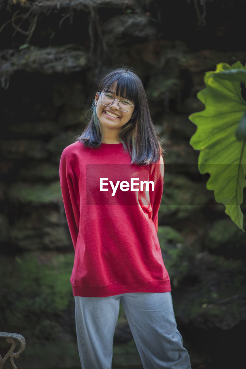 Portrait of asian teenager wearing eyeglasses standing outdoor