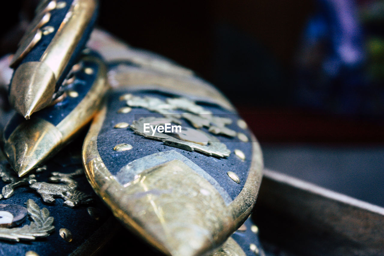 CLOSE-UP OF METAL ON TABLE AT HOME