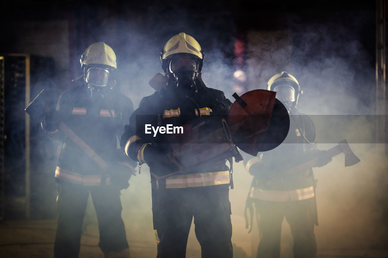 People holding equipment while standing on land