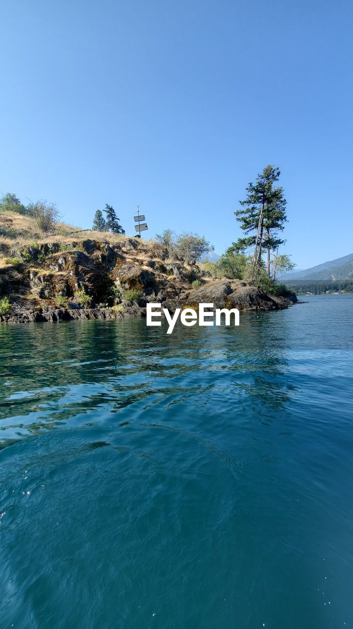 water, nature, blue, plant, tree, sea, sky, beauty in nature, day, terrain, reflection, scenics - nature, no people, ocean, outdoors, land, clear sky, palm tree, tropical climate, tranquility, coast, beach, wave
