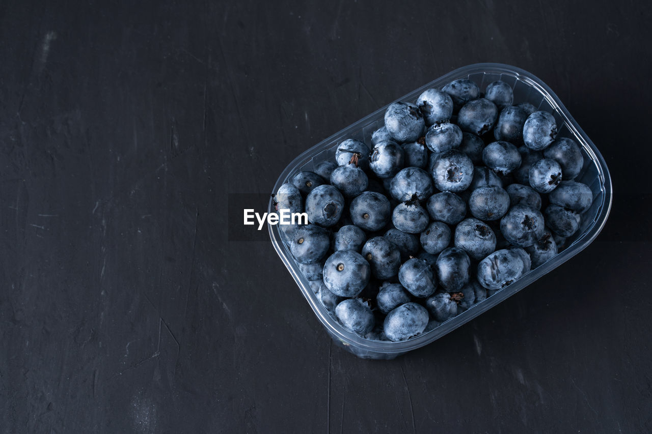 High angle view of blueberries in bowl on table