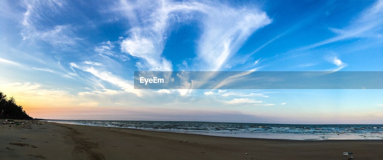 Scenic view of beach against sky during sunset