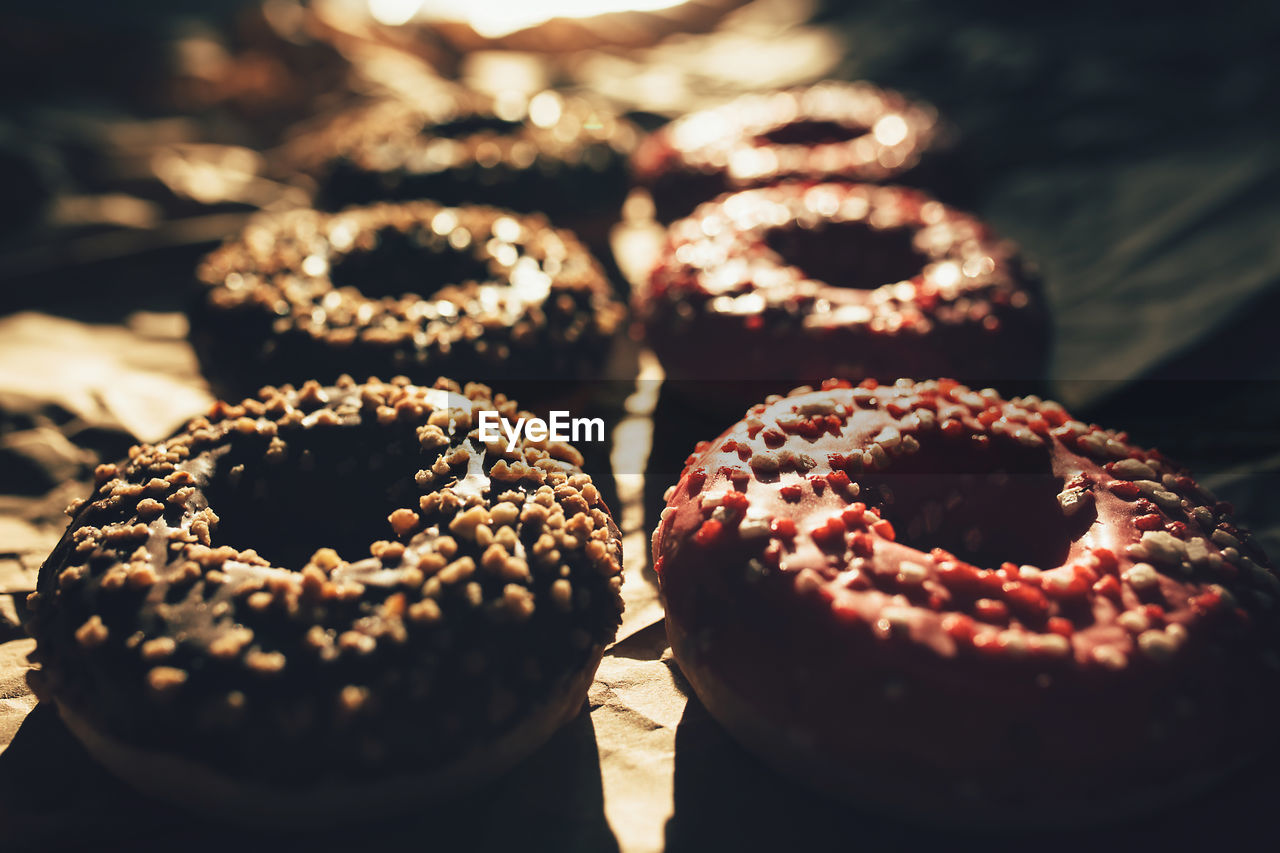 Fresh chocolate and raspberry donuts on crumpled craft paper. high quality photo