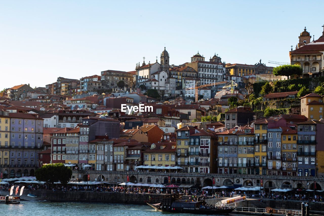 Buildings in city against clear sky