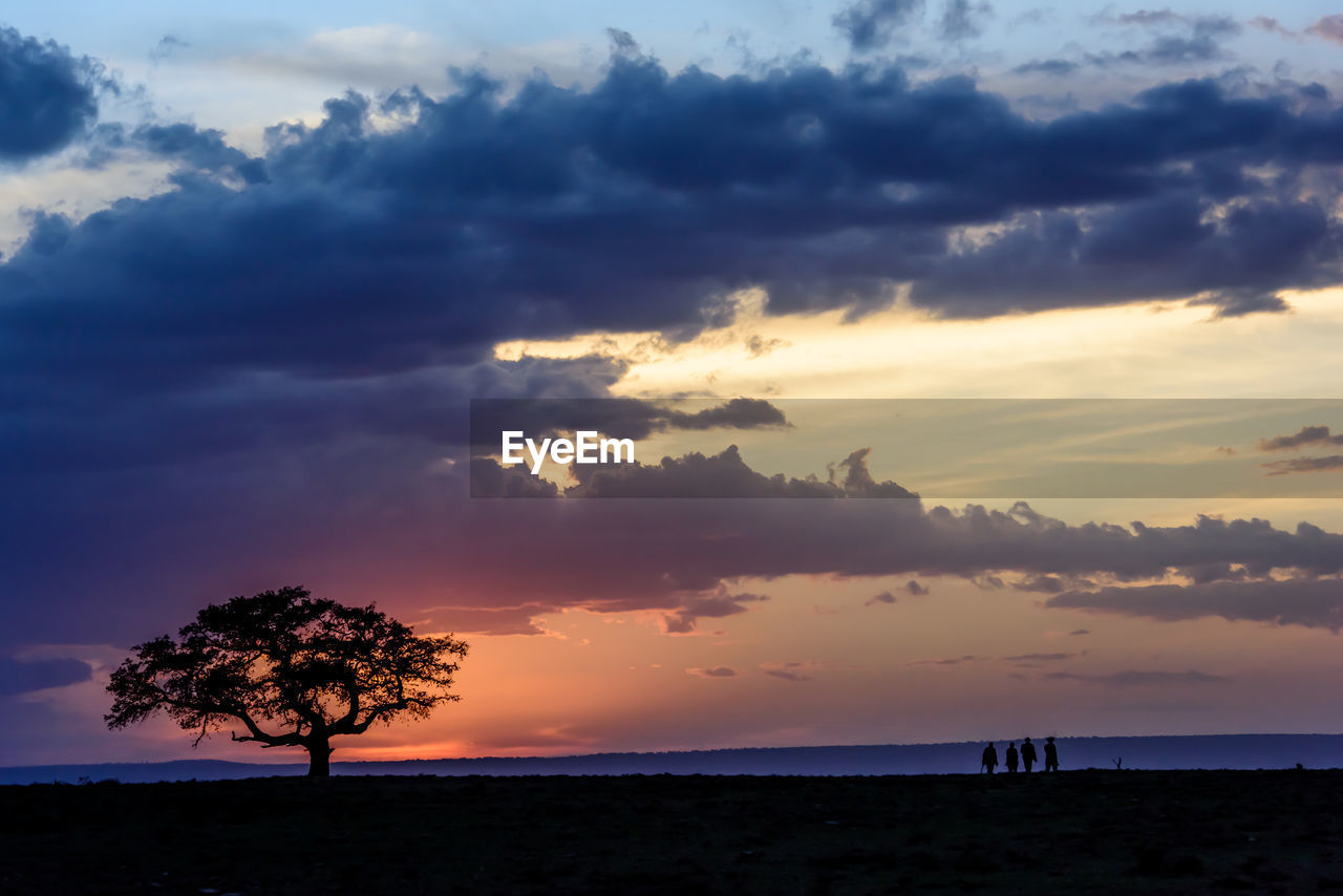 Scenic view of sea against cloudy sky during sunset