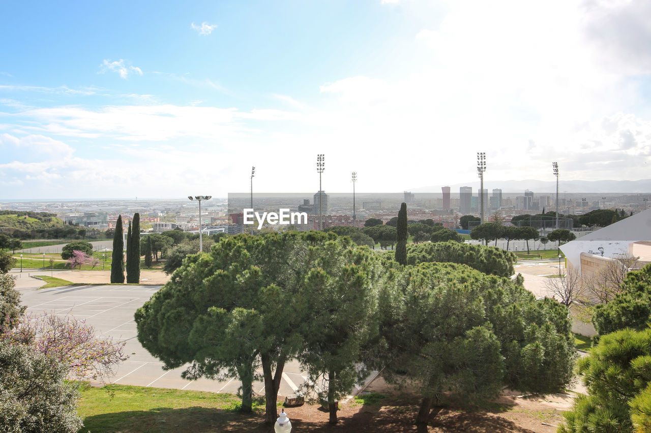 PANORAMIC VIEW OF TREES AND CITY AGAINST SKY