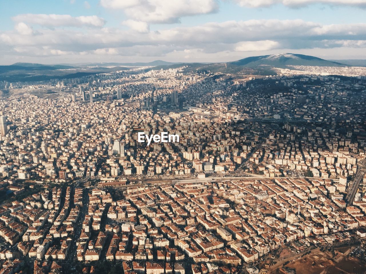 High angle view of cityscape against cloudy sky