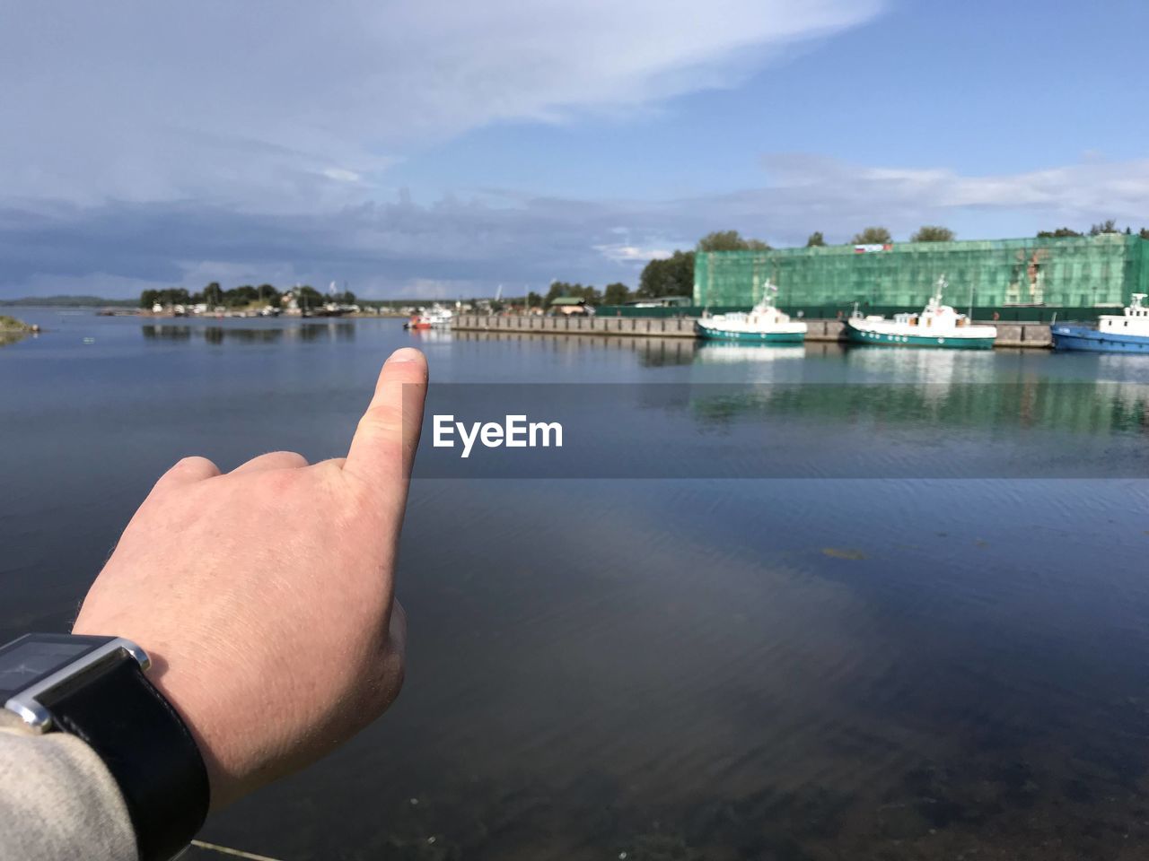 MIDSECTION OF PERSON IN SEA AGAINST SKY