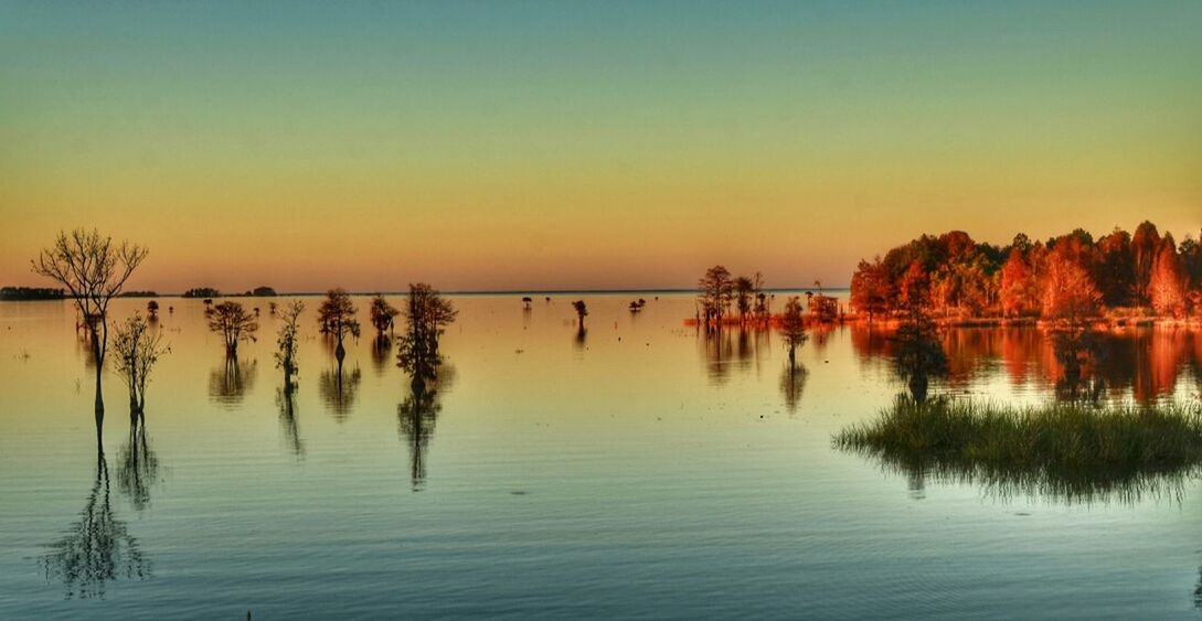 SCENIC VIEW OF SUNSET OVER RIVER