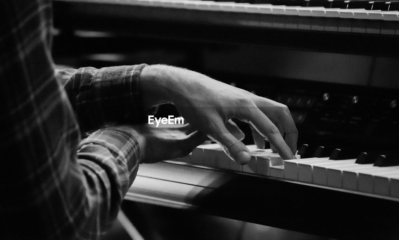 Close-up of man playing piano